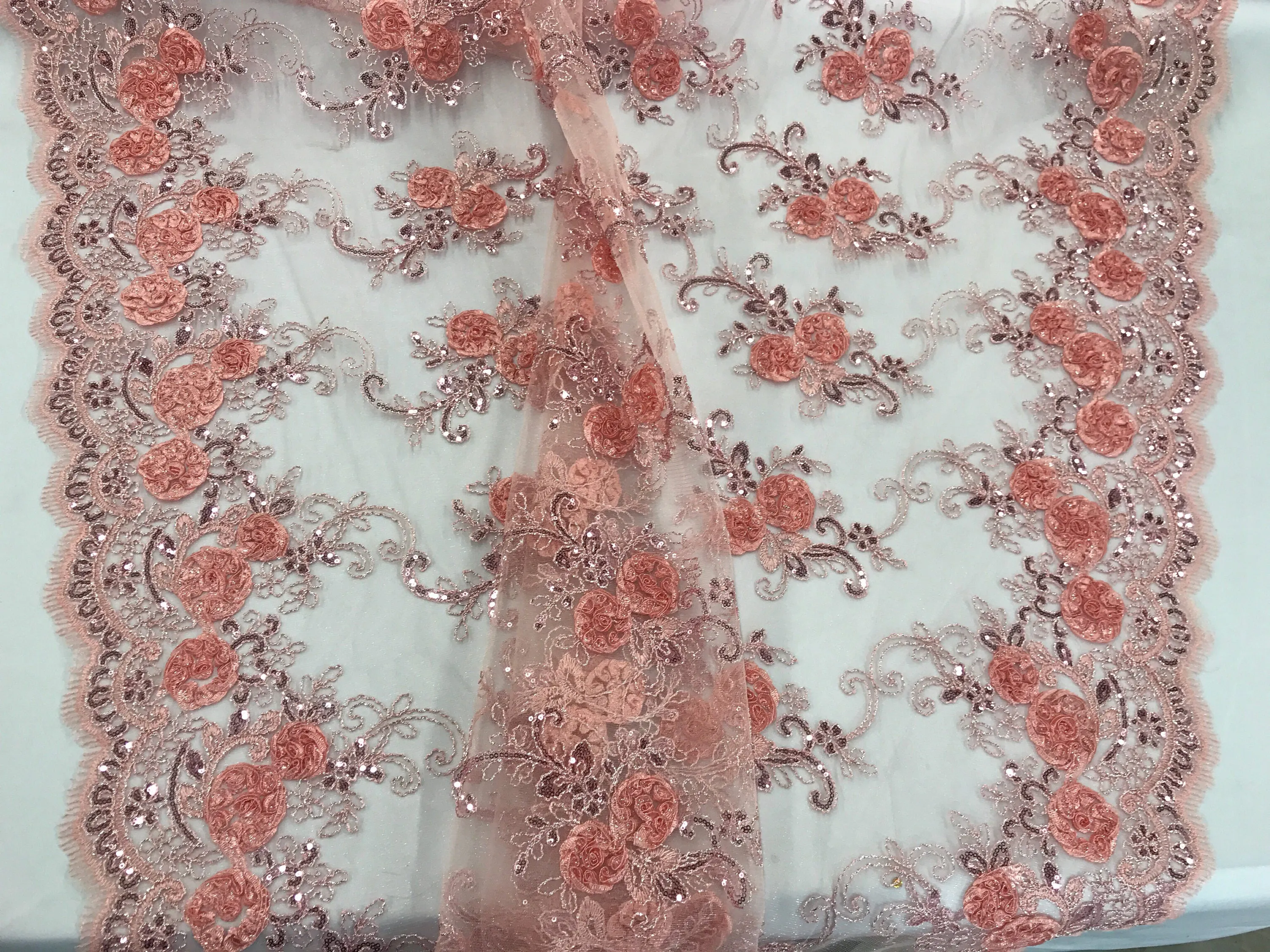 Blush peach  3d flowers embroider with sequins on a mesh lace fabric. Sold by the yard.