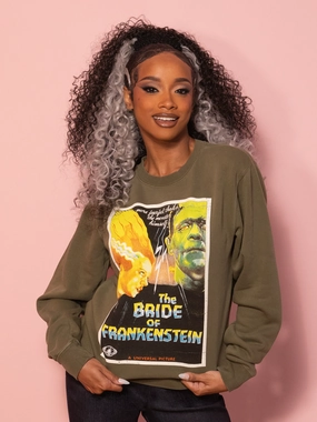 Garment Dye Technique Universal Monsters: Bride of Frankenstein Vintage Movie Poster Sweatshirt in Green (unisex) Holiday Casual Universal Monsters: Bride of Frankenstein Vintage Movie Poster Sweatshirt in Green (unisex)