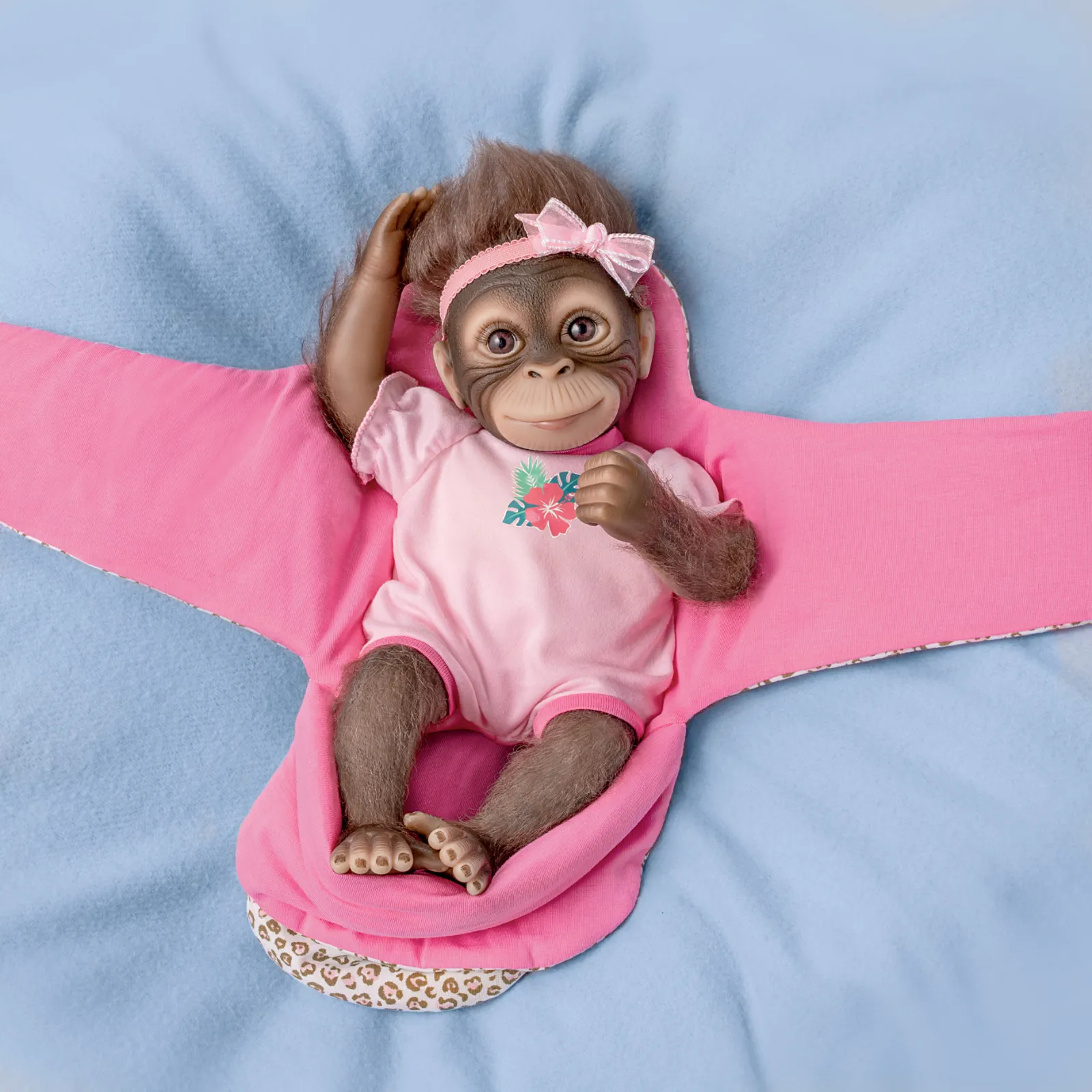 The Ashton - Drake Galleries Snuggle Suri Lifelike Baby Monkey Girl Doll With RealTouch® Vinyl Skin and Weighted Cloth Body Hand Applied Mohair Magnetic Pacifier Leopard Print Bunting 14"-inches